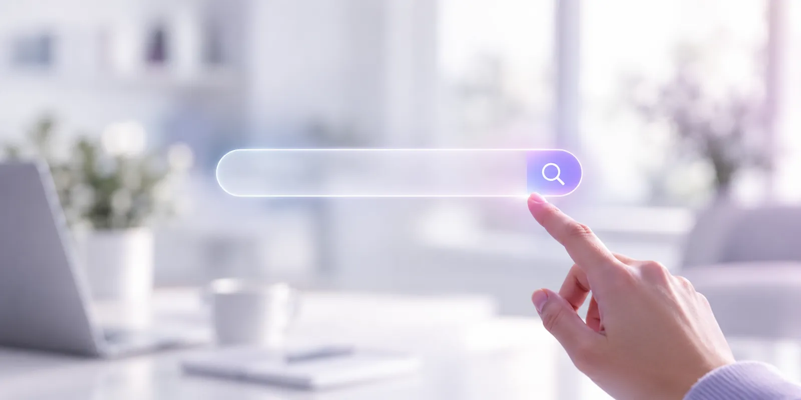 A finger touching a glowing search bar, in front of a bright desk
